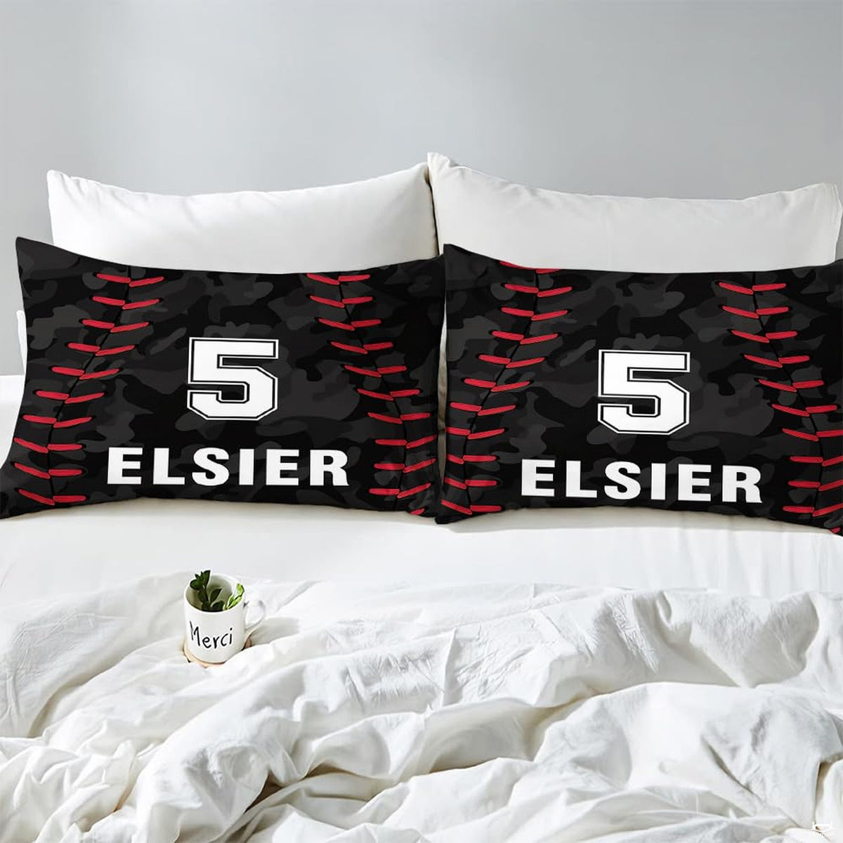 Side angle view of athletic sports bedding showing vivid red and midnight black tones draped on mattress