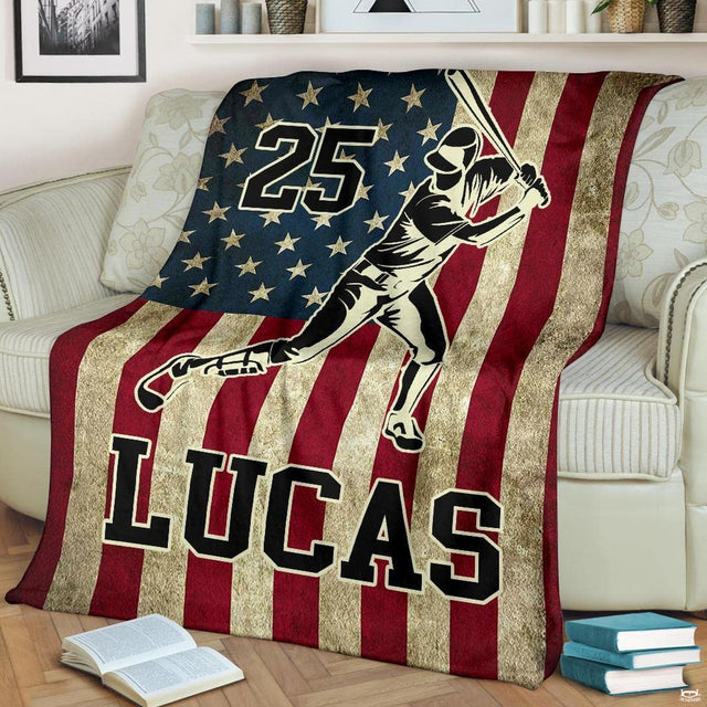 Living room display showing patriotic baseball batter artwork draped over a cream sofa.