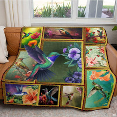 Close-up of vibrant avian illustrations and tropical blooms on hummingbird bed cover artwork.