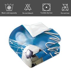Angled perspective of blue bokeh soccer bedding showing white cursive script typography