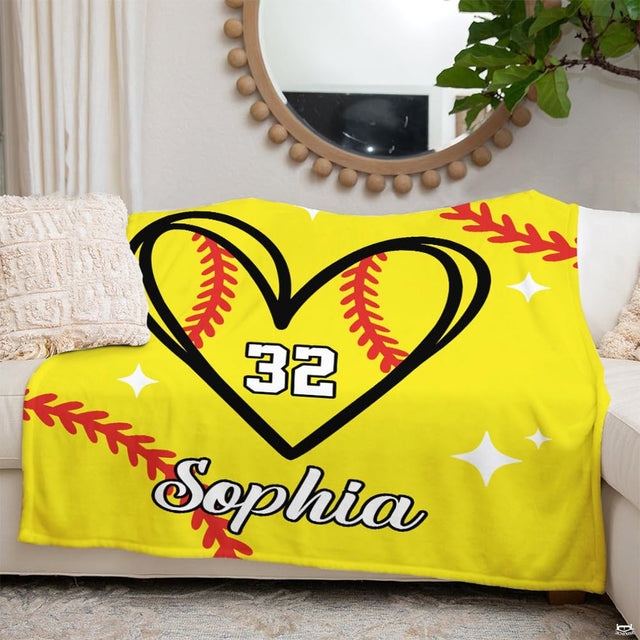 Detail perspective of red softball seam lacing inside heart outline on sports throw blanket.