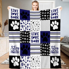 Navy dog paw print patchwork throw blanket with bold puppy paws and chevron zigzag blocks
