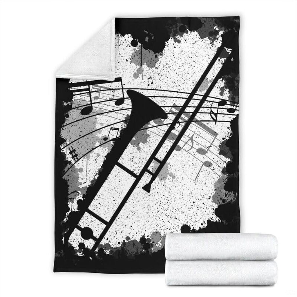 Trombone music graphic blanket spread across a bed in a modern room setting.