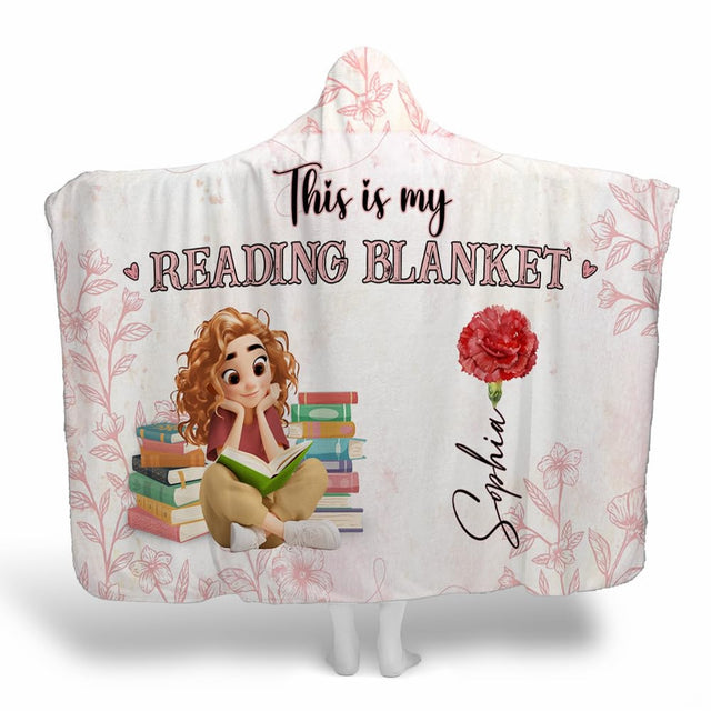 Pink botanical book lover throw blanket showing illustrated girl, stacked novels, and scarlet carnation