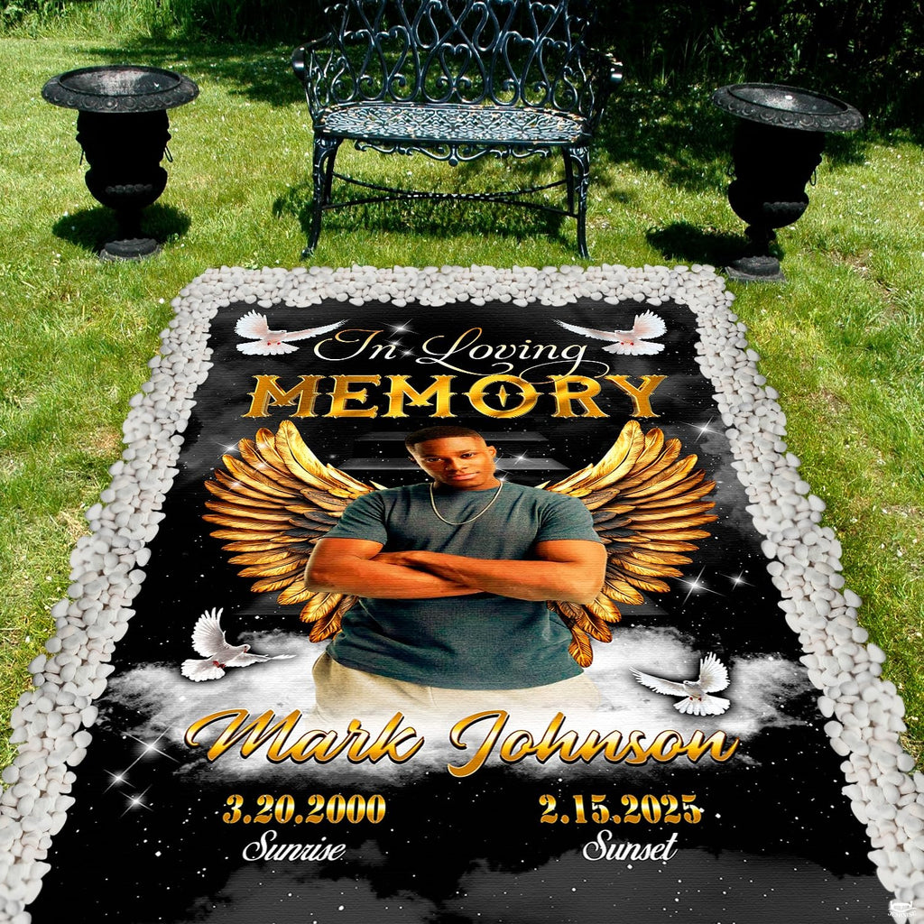 Outdoor cemetery garden perspective featuring angel wings tribute between decorative urns and a park bench.