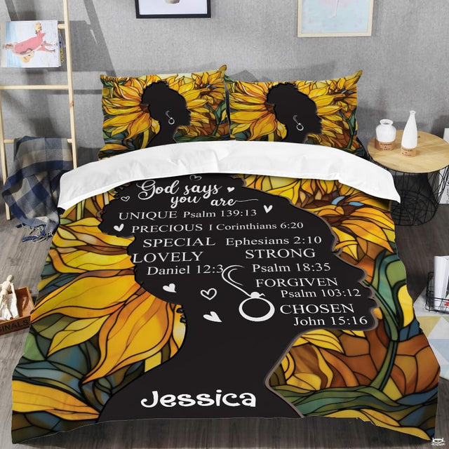 Close-up view of sunflower bedding highlighting vivid golden petals, ornate cross, and scripture typography