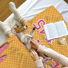 Angle view of ice cream baseball bedding set highlighting rich amber hues and vibrant sports graphics.