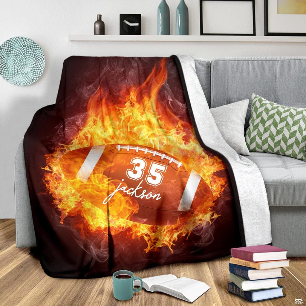 Blazing football graphic blanket displayed on living room armchair
