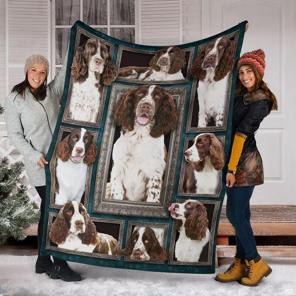 Two models displaying the English Springer Spaniel blanket outside a snowy winter home entrance.