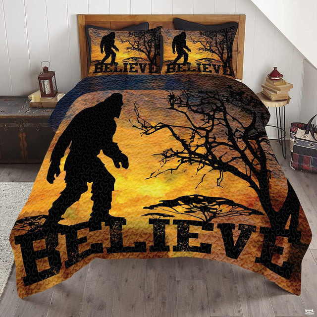 Retro sunset Believe Bigfoot bedding set featuring a Sasquatch silhouette and golden sunset stripes on a bed