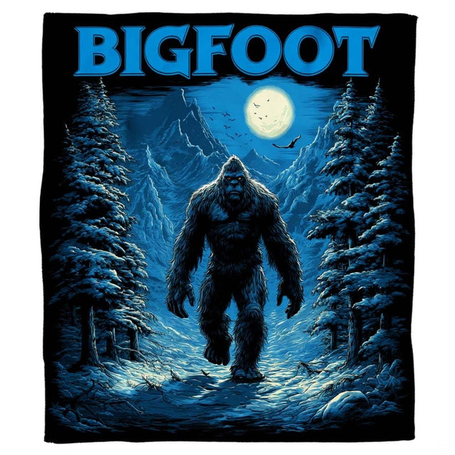 Winter Bigfoot throw blanket view 2 highlighting blue moonlight, snowy alpine trees, and mountainous terrain