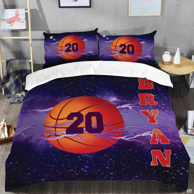 Bold athletic typography and textured orange basketball artwork on a celestial galaxy bedding set.