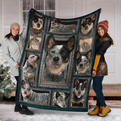 Two models displaying the Australian Cattle Dog blanket outside a snowy winter home entrance.
