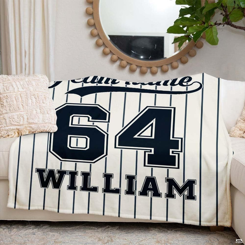 Angled view of collegiate athletic block numbers and baseball script design on off-white background.