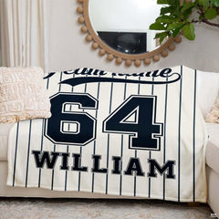 Angled view of collegiate athletic block numbers and baseball script design on off-white background.