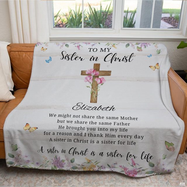 Living room sofa display showing the religious floral cross throw blanket draped over furniture.