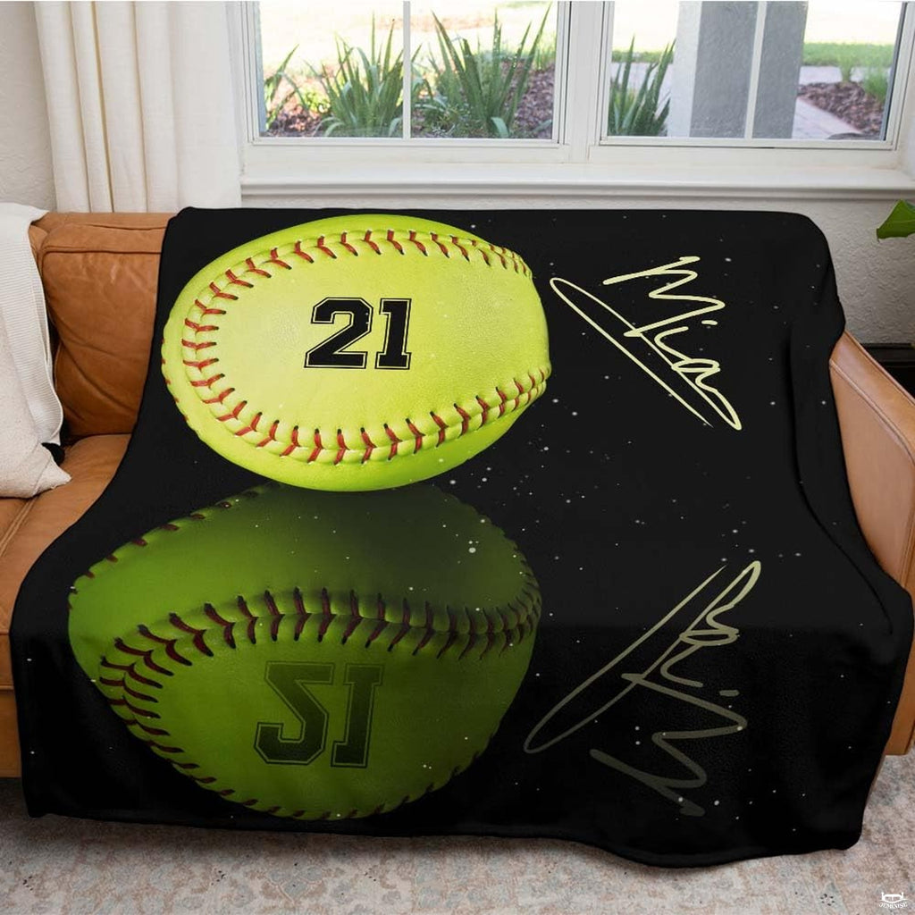 Softball blanket draped across brown leather living room sofa beneath sunny window