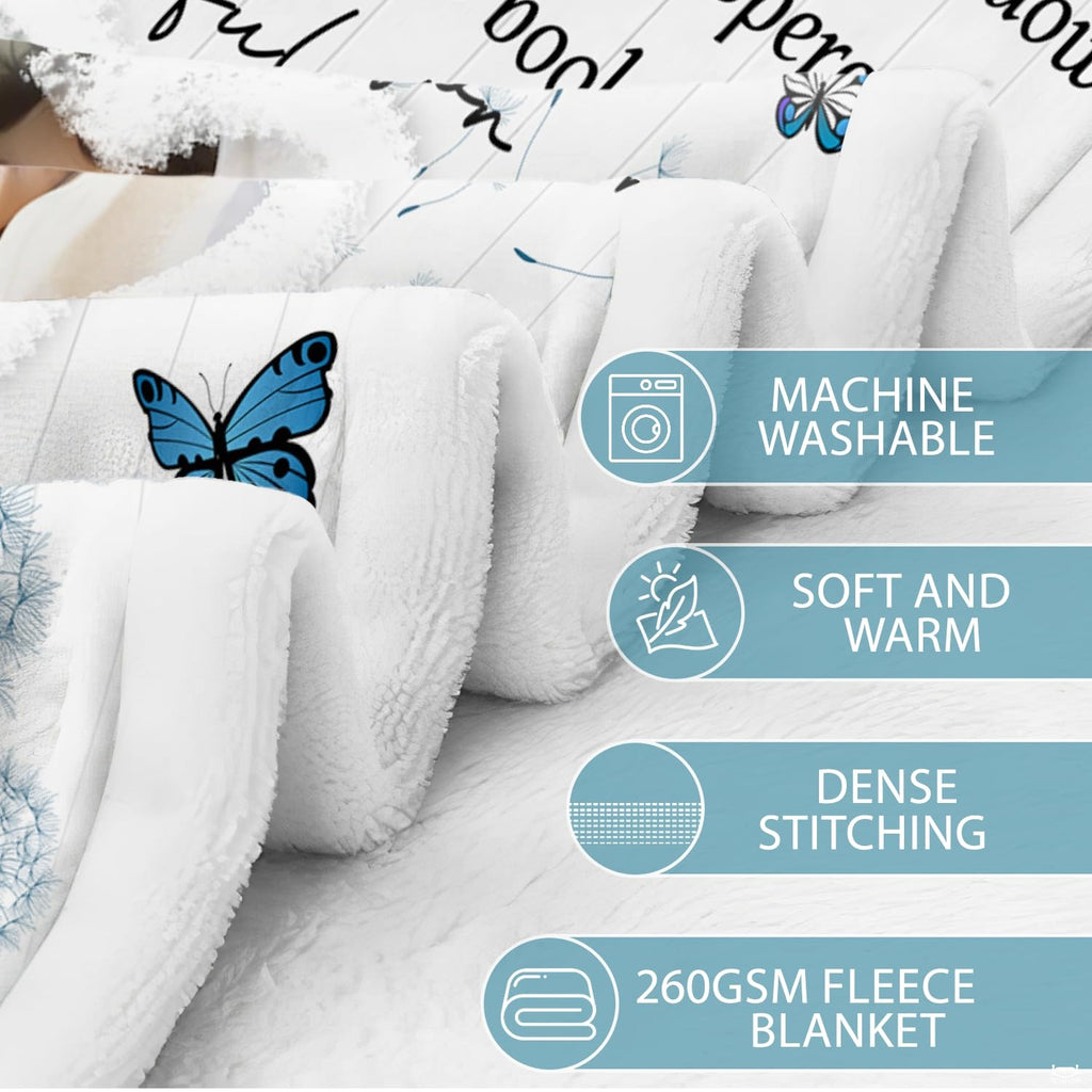 Living room sofa displaying the commemorative blue butterfly throw blanket draped over furniture.