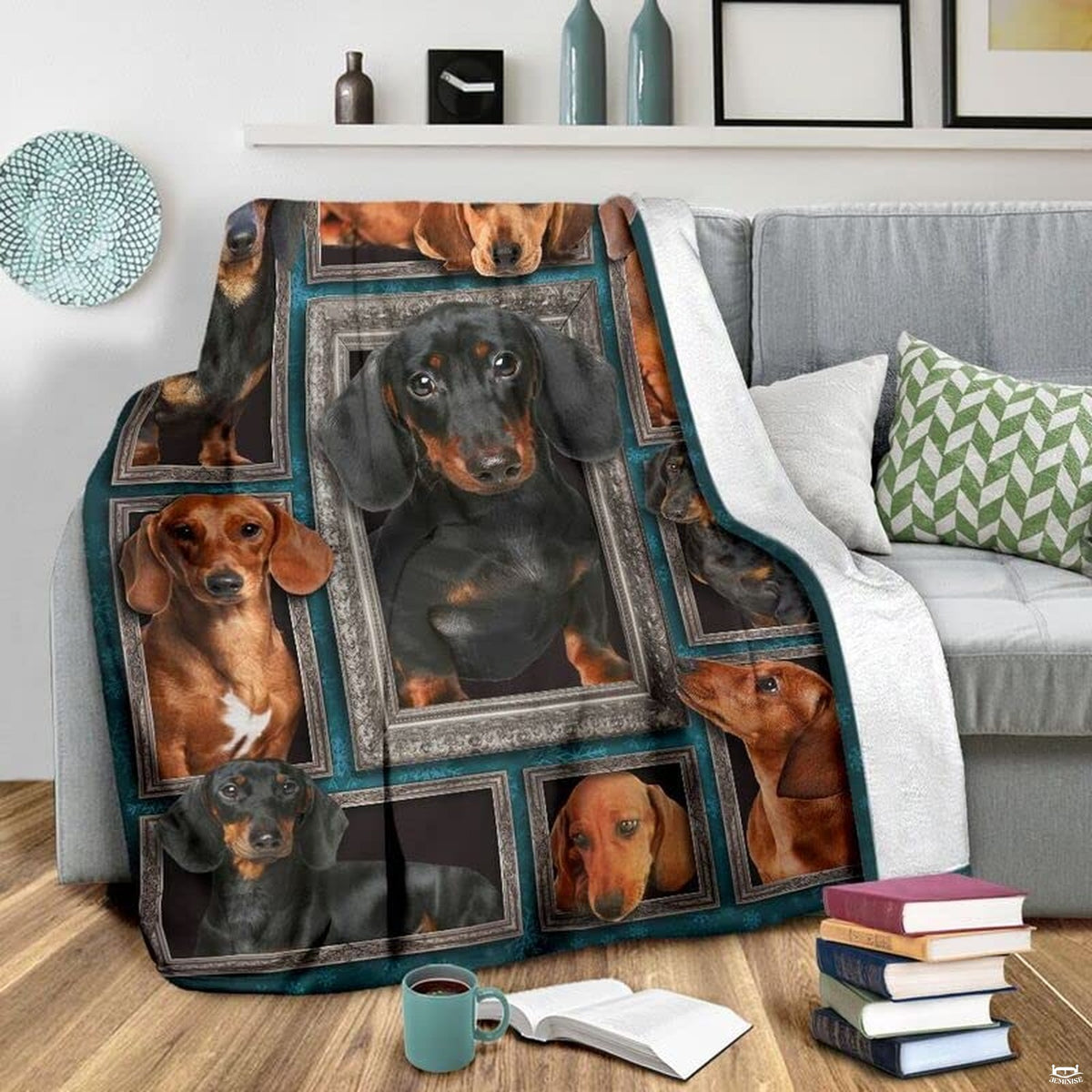 Grey couch arrangement featuring the Dachshund blanket draped beside patterned pillows.