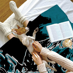 Overview of teal and black motocross bedding in an urban bedroom interior.