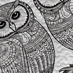 Close-up view of owl bedding highlighting detailed white feather plumage, curved beak, and golden eyes