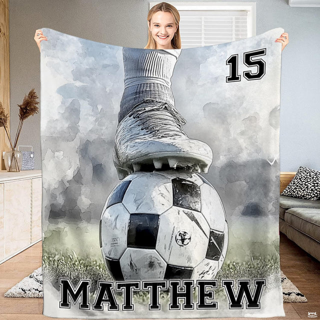 Soccer ball bed bedding set displaying a watercolor cleat resting on a ball across a grassy pitch backdrop.