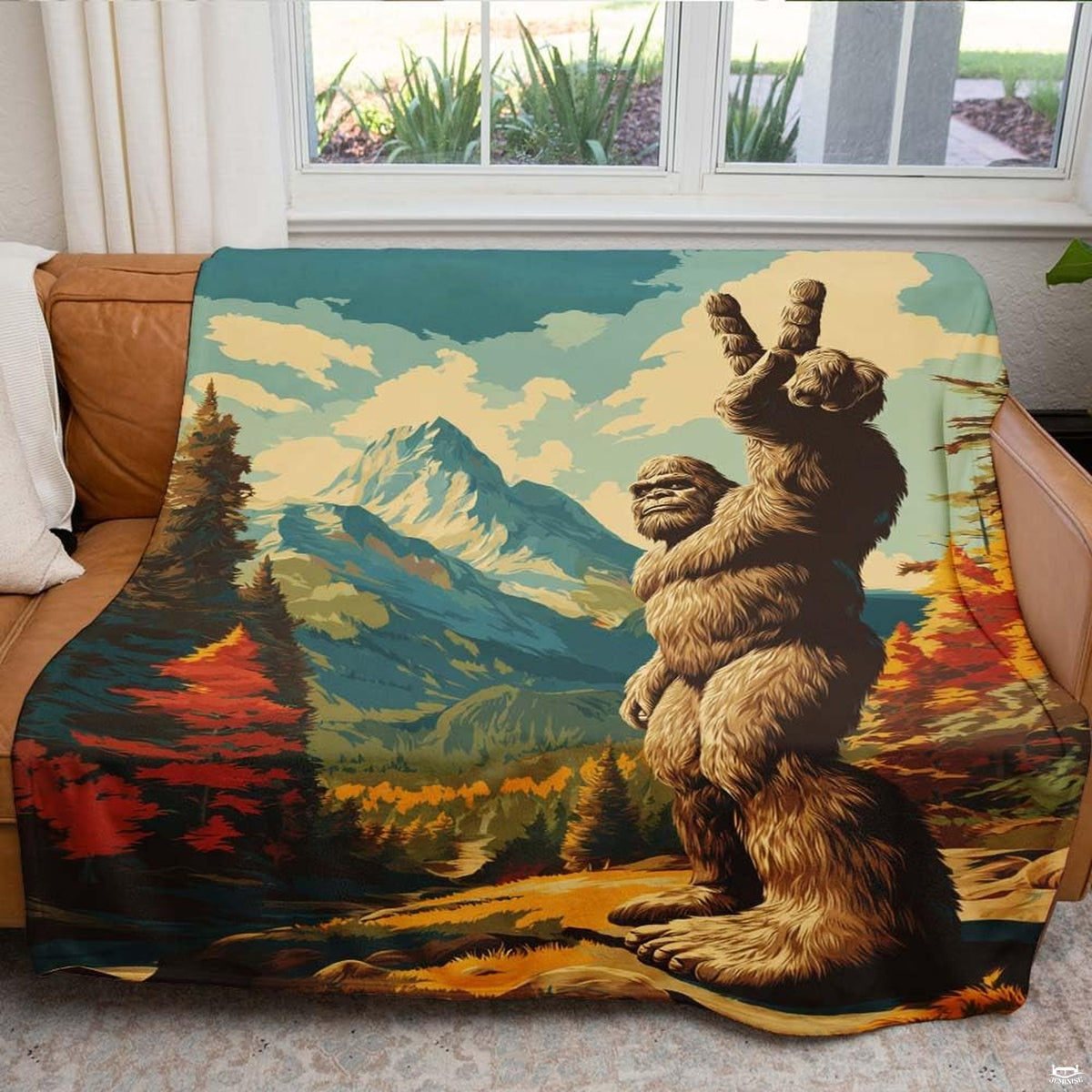 Bigfoot sasquatch peace sign blanket draped over leather living room sofa
