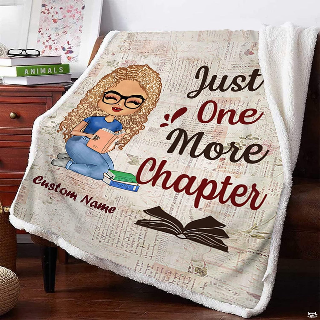 Lifestyle display of folded literary coverlet staged across wooden armchair next to nightstand.