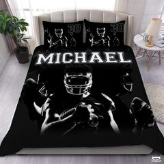 Monochrome football player sports bedding set displayed on bed with matching pillowcases