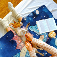 Artistic detail of whimsical dragon gliding across deep blue twilight sky on bedding set.