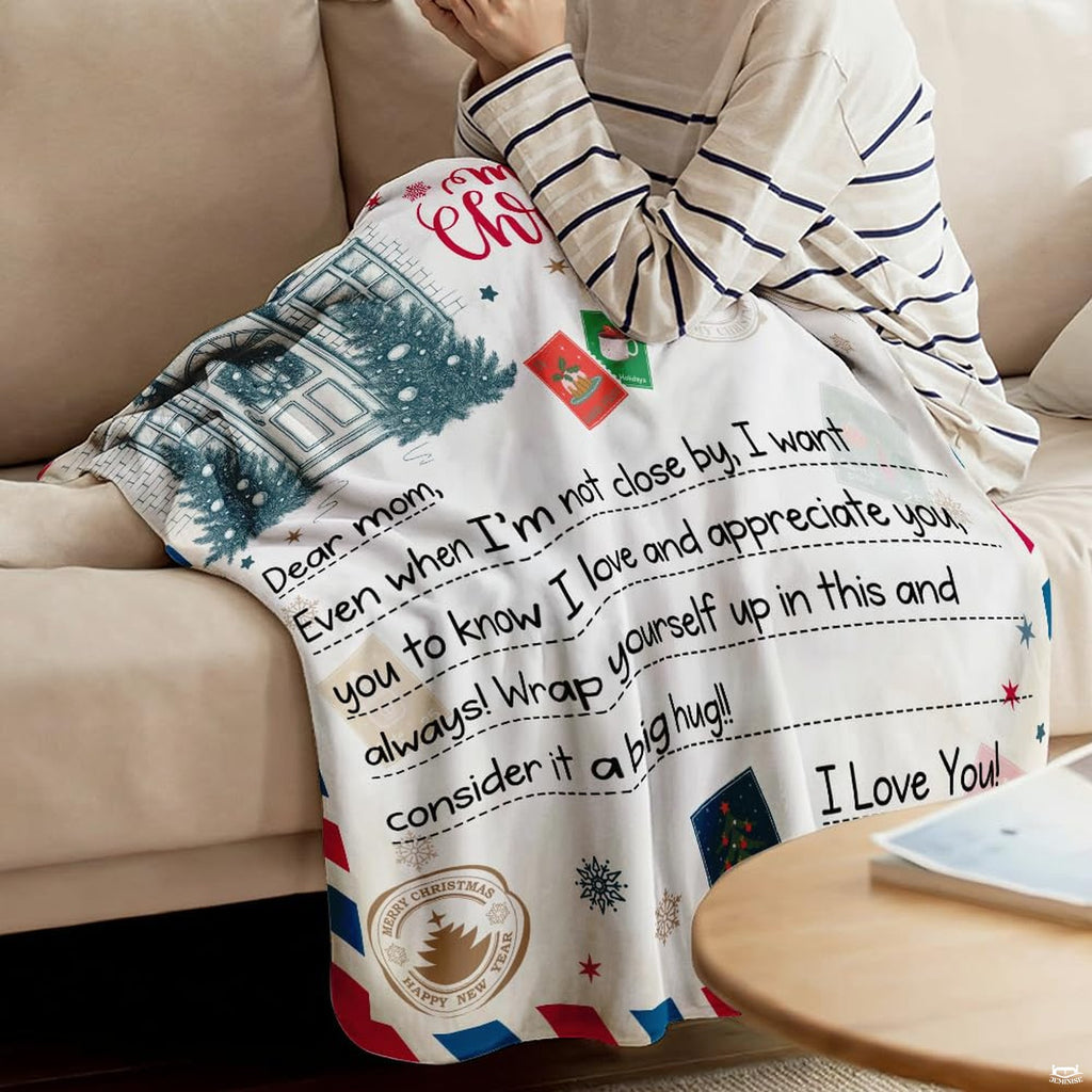 Close-up of vintage postal stamps, cancellation postmarks, and handwritten letter text on a blanket