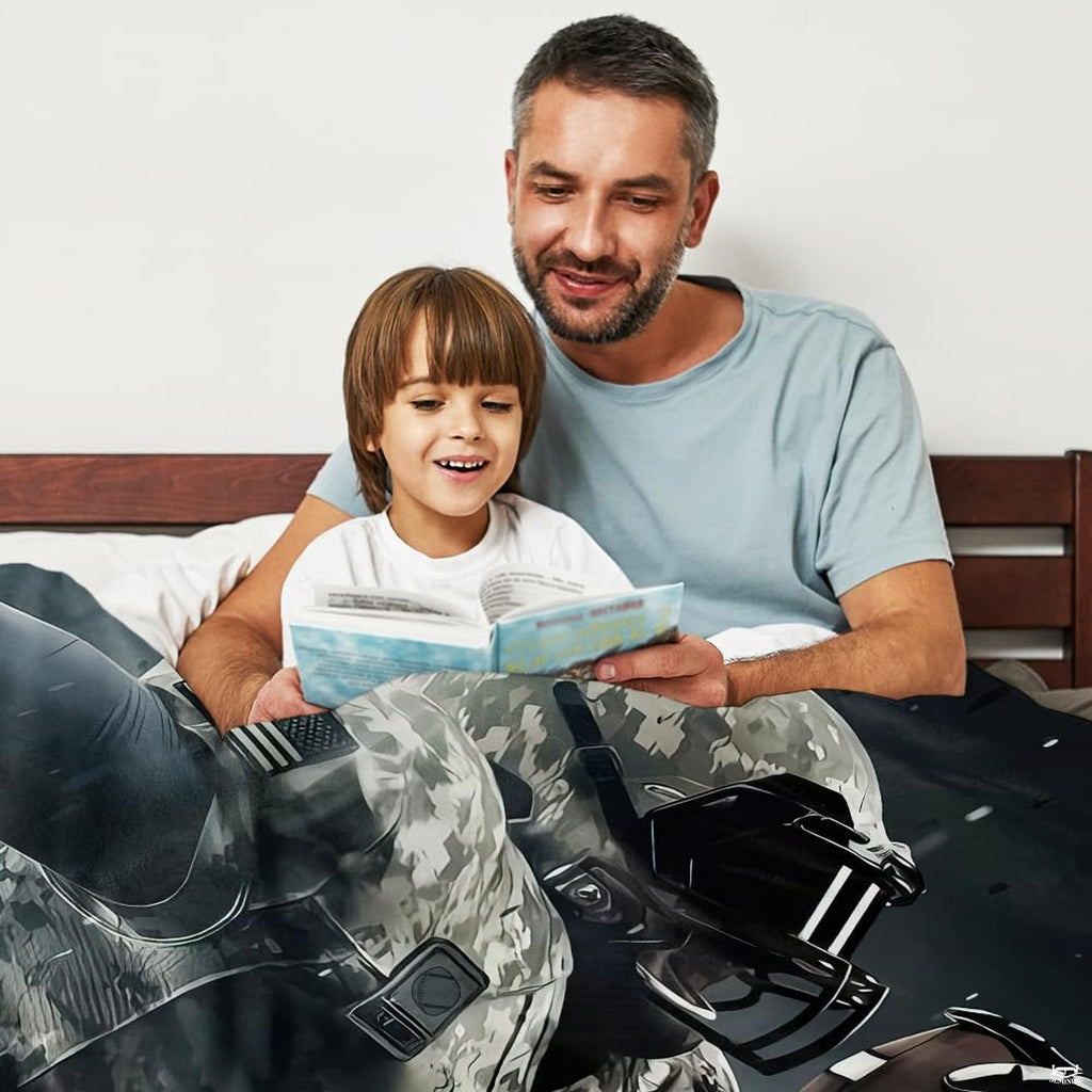 Adult and child reading in bed draped under camo football player throw blanket