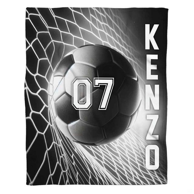 Soccer ball hitting goal net graphic textile laid flat in studio