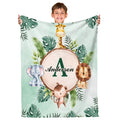 Safari jungle throw blanket featuring watercolor giraffe, elephant, lion, and monkey around wood slice.