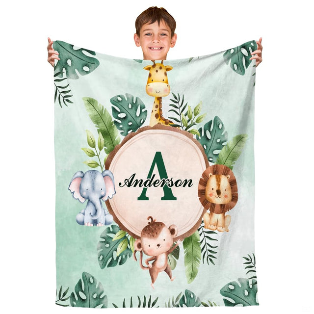 Safari jungle throw blanket featuring watercolor giraffe, elephant, lion, and monkey around wood slice.
