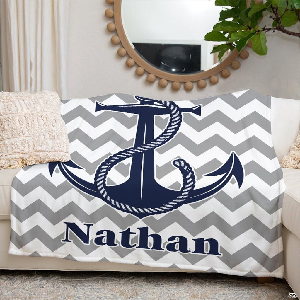 Detailed view of the twisted nautical rope and anchor graphic rendered in deep navy blue on coastal bedding.