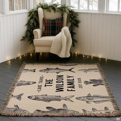 Vintage fish engraving throw blanket styled on velvet armchair in rustic living space
