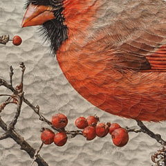 Close-up of naturalist illustration featuring a red cardinal perched on berry branches on bedding.