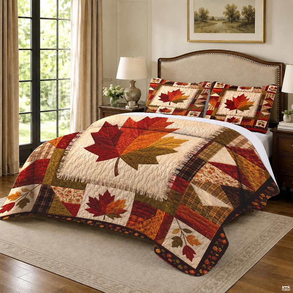 Top-down view of patchwork maple leaf autumn bedding set neatly displayed on a rustic farmhouse mattress