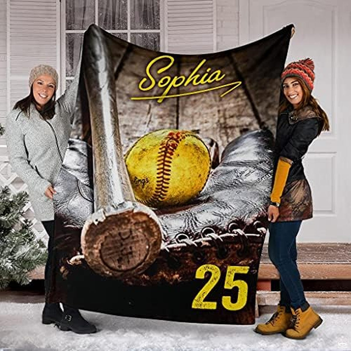 Two friends holding up the sports equipment graphic outdoors in a winter setting.
