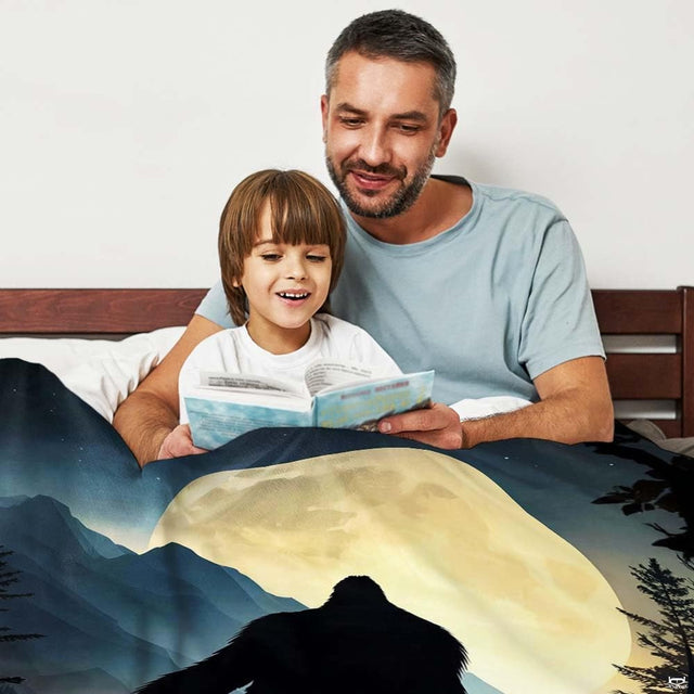 Detailed artwork showing Sasquatch among alpine evergreens in rich indigo nocturnal tones.