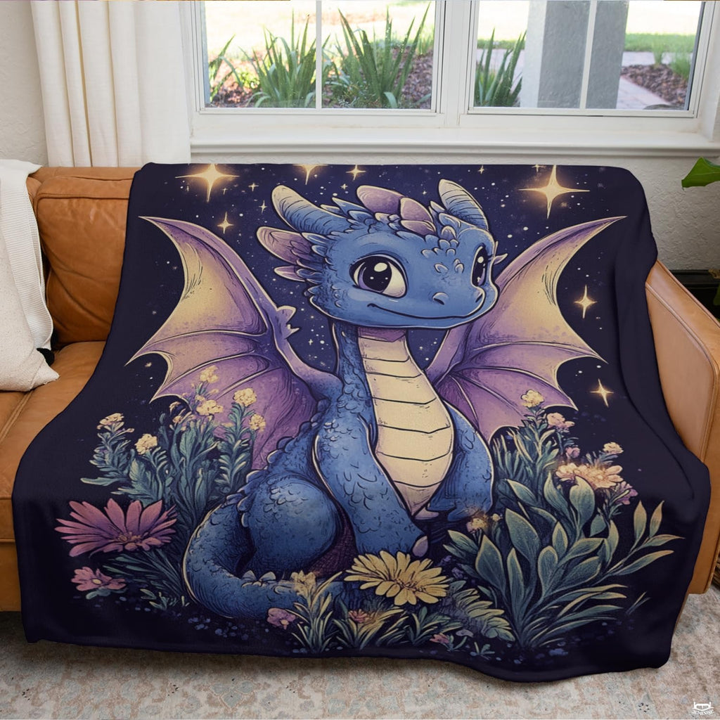 Illustrated baby blue dragon starry meadow throw blanket folded neatly on an armchair.