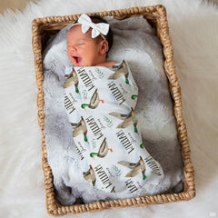 Scenic lakeside waterfowl print bedding styled with wooden bedroom furniture and country outdoor design accents