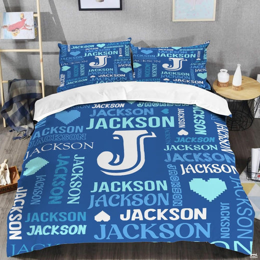 Blue monogram bedding displaying crisp white initial letter surrounded by royal blue and cyan word-cloud typography
