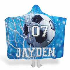 Display showing soccer goal net blanket featuring striking ball and stadium lighting on blue background