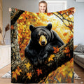 Autumn black bear tree branch throw blanket held open by woman