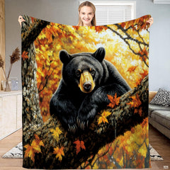 Autumn black bear tree branch throw blanket held open by woman