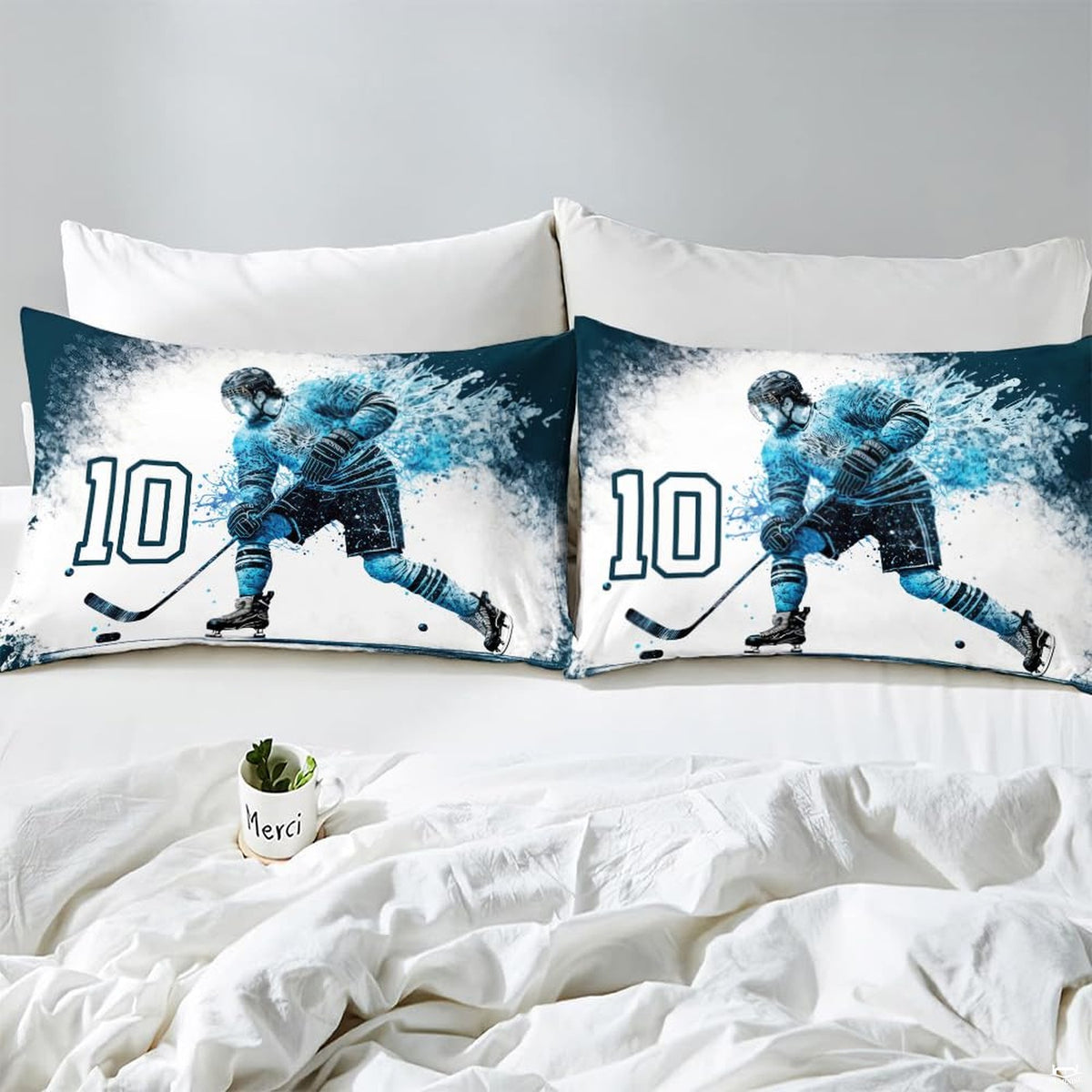 Side angle view of athletic winter sports bedding showing icy blue and deep navy tones draped on mattress