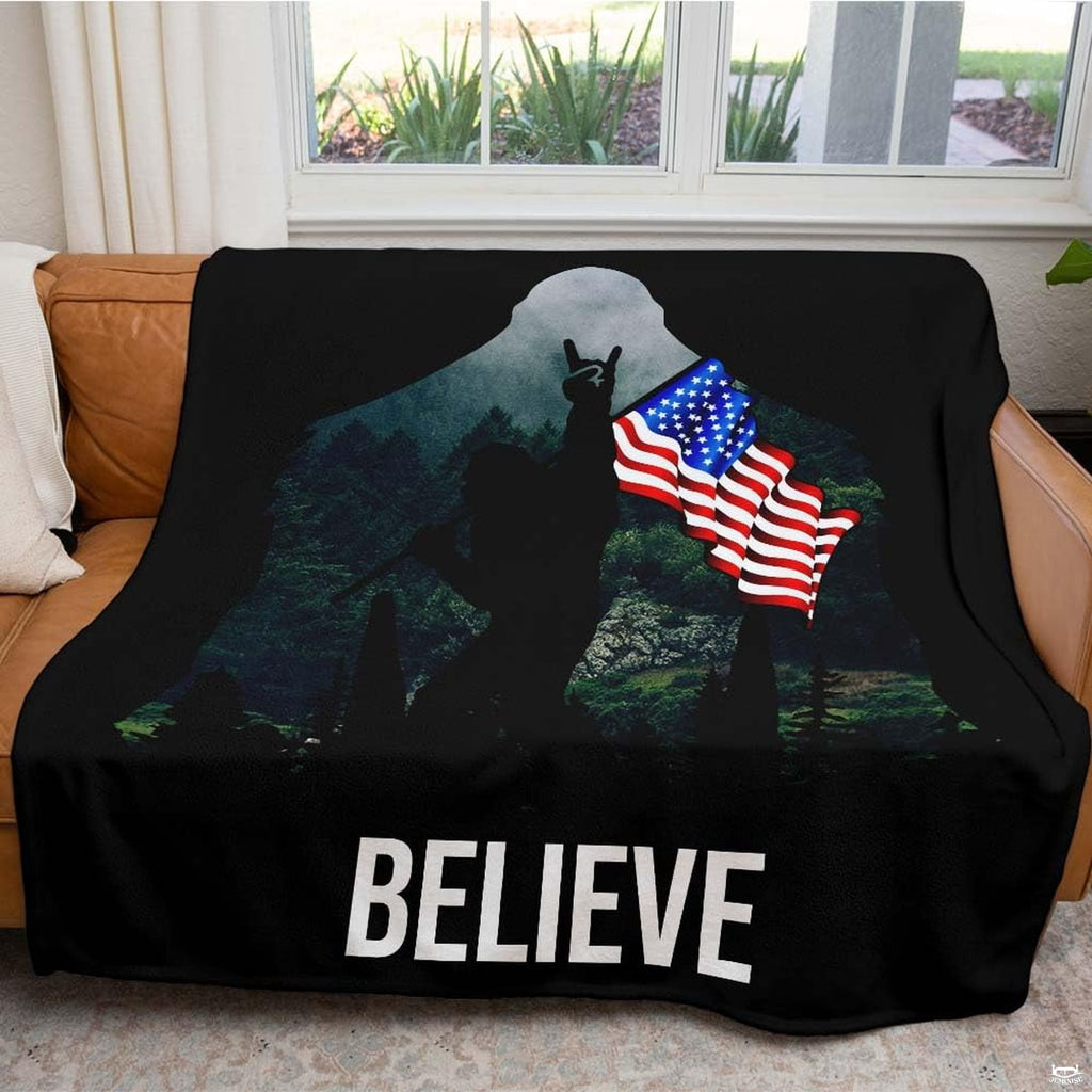 Detailed graphic view of moonlit pine trees and Stars and Stripes inside Sasquatch outline.