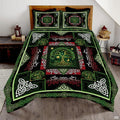 Celtic Tree of Life sun moon green bedding displayed on wooden bed with matching pillowcases.